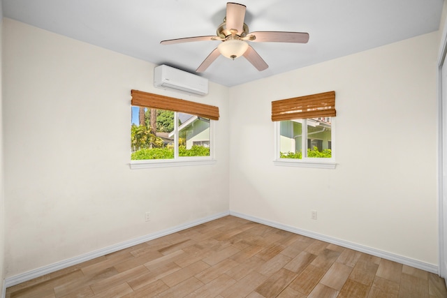 5372 Kumole St, Kapaa, HI 96746 - spare room featuring a wall mounted air conditioner, light wood-style floors, baseboards, and ceiling fan