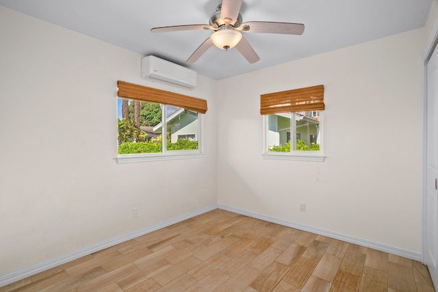 5372 Kumole St, Kapaa, HI 96746 - unfurnished room featuring a wall unit AC, light wood-style floors, baseboards, and a ceiling fan