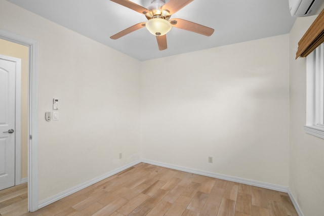 5372 Kumole St, Kapaa, HI 96746 - spare room featuring light wood-type flooring, a wall mounted AC, baseboards, and ceiling fan