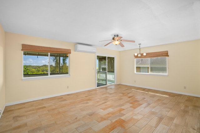 5372 Kumole St, Kapaa, HI 96746 - empty room with a wall unit AC, a ceiling fan, light wood finished floors, and plenty of natural light