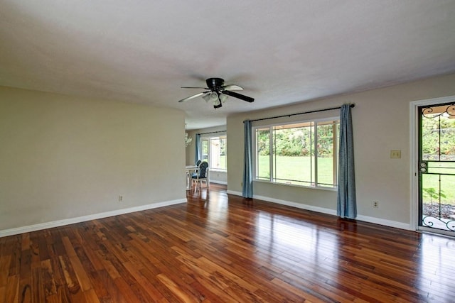 unfurnished room with ceiling fan and dark hardwood / wood-style floors