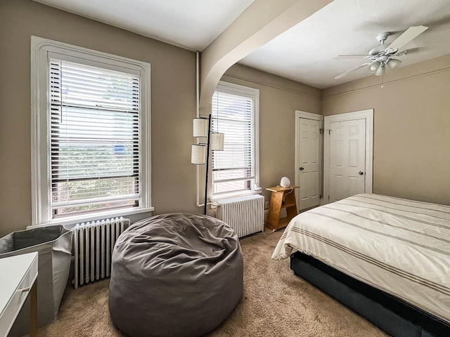 bedroom featuring carpet, ceiling fan, and radiator