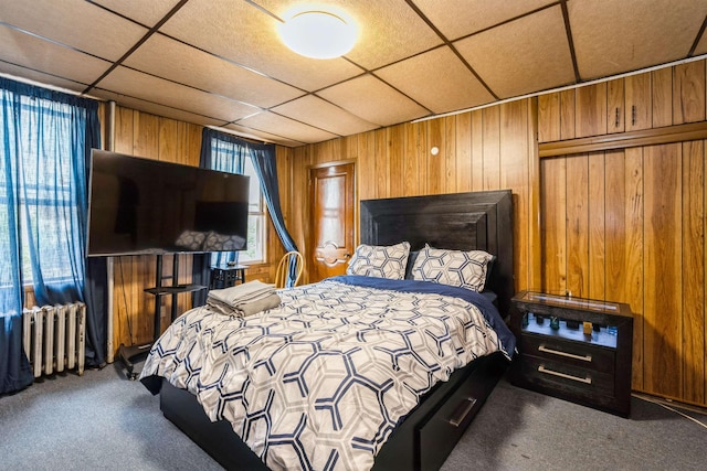 73 Laidlaw Ave, Jersey City, NJ 07306 - carpeted bedroom featuring radiator heating unit, wood walls, and a paneled ceiling