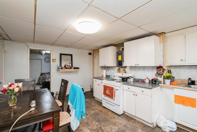 73 Laidlaw Ave, Jersey City, NJ 07306 - kitchen featuring gas range gas stove, a drop ceiling, white cabinetry, backsplash, and dark countertops