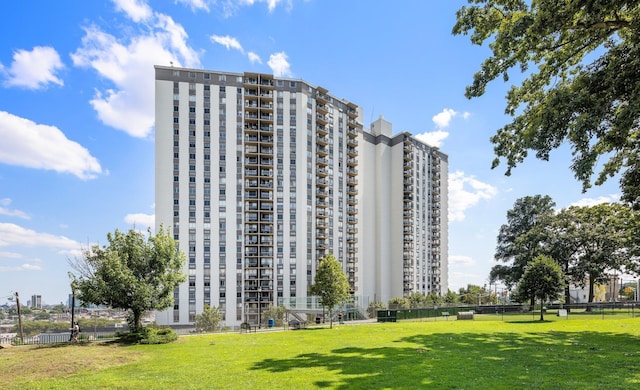 view of apartment building / complex featuring fence