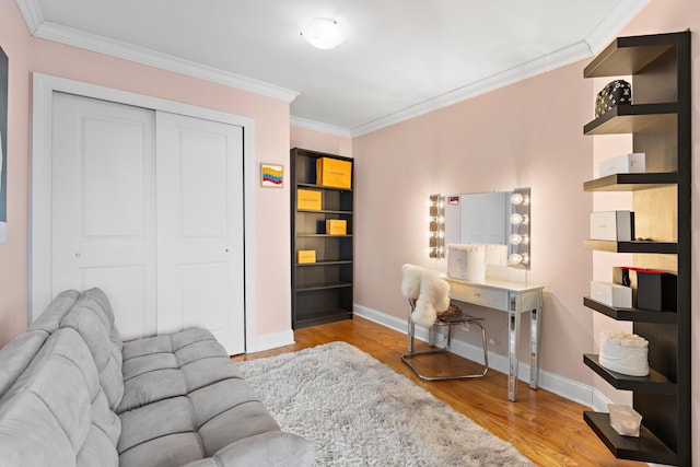 office with baseboards, wood finished floors, and crown molding