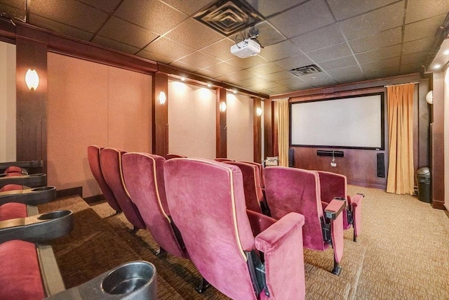 home theater room featuring carpet, a paneled ceiling, and visible vents