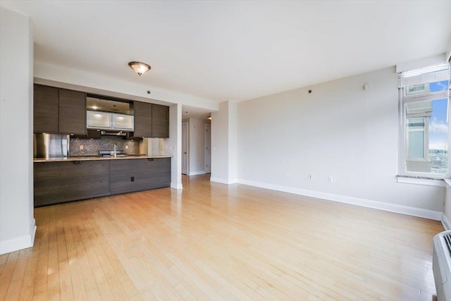 unfurnished living room with light wood-style floors and baseboards