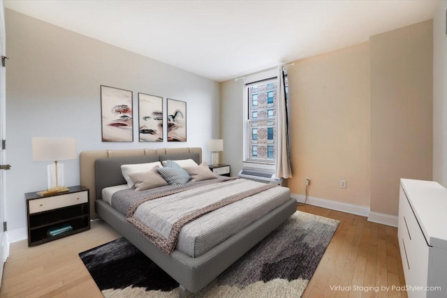 bedroom featuring light wood-style floors and baseboards