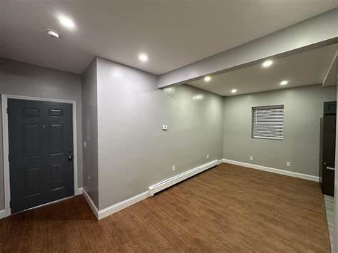 below grade area featuring baseboard heating, wood finished floors, baseboards, and recessed lighting