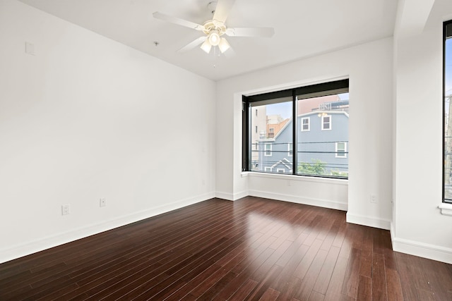 471 Monmouth St Unit 1, Jersey City, NJ 07302 - empty room with dark wood-style floors, baseboards, and ceiling fan