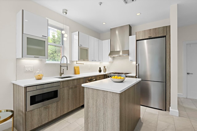 471 Monmouth St Unit 1, Jersey City, NJ 07302 - kitchen featuring stainless steel appliances, wall chimney exhaust hood, a sink, modern cabinets, and backsplash