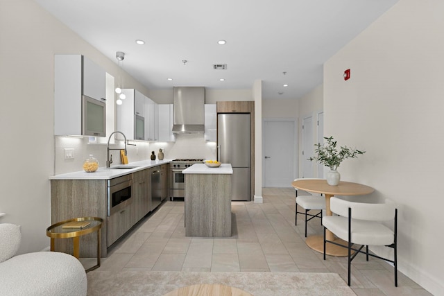 471 Monmouth St Unit 1, Jersey City, NJ 07302 - kitchen with a sink, wall chimney range hood, modern cabinets, appliances with stainless steel finishes, and recessed lighting
