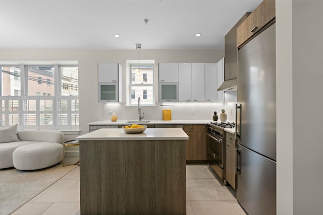 471 Monmouth St Unit 1, Jersey City, NJ 07302 - kitchen with stainless steel appliances, a sink, plenty of natural light, light tile patterned flooring, and recessed lighting