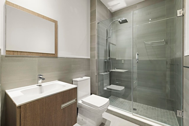471 Monmouth St Unit 1, Jersey City, NJ 07302 - bathroom with toilet, tile walls, vanity, and a stall shower