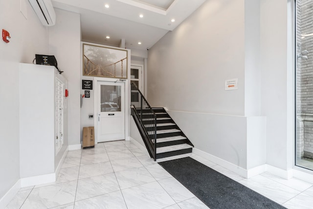 126 Delaware Ave Unit 10, Jersey City, NJ 07306 - stairway with marble finish flooring, a wall mounted AC, recessed lighting, baseboards, and a high ceiling