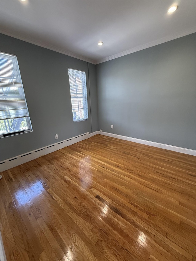 53 64th St Unit 3, West New York, NJ 07093 - empty room featuring a baseboard radiator, wood-type flooring, ornamental molding, and recessed lighting