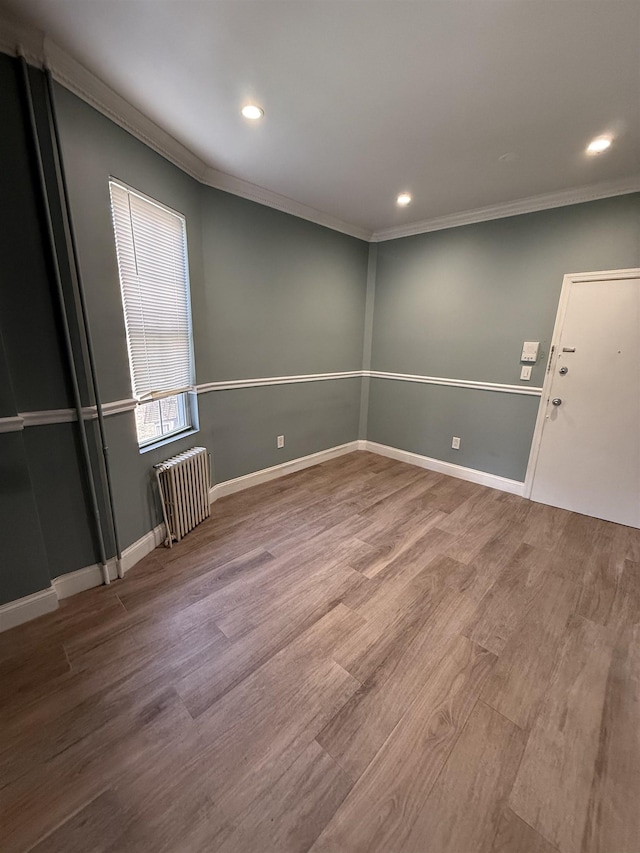 53 64th St Unit 3, West New York, NJ 07093 - unfurnished room with radiator heating unit, ornamental molding, wood finished floors, and recessed lighting