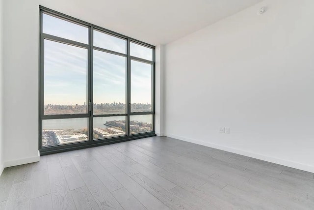 320 Adolphus Ave Unit 316, Cliffside Park, NJ 07010 - empty room with a wall of windows, wood finished floors, and baseboards