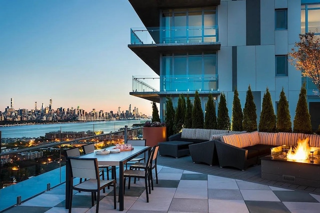 320 Adolphus Ave Unit 316, Cliffside Park, NJ 07010 - view of patio / terrace with an outdoor living space with a fire pit, a skyline view, a balcony, and outdoor dining space