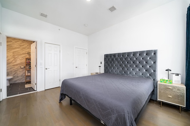 bedroom with visible vents and wood finished floors