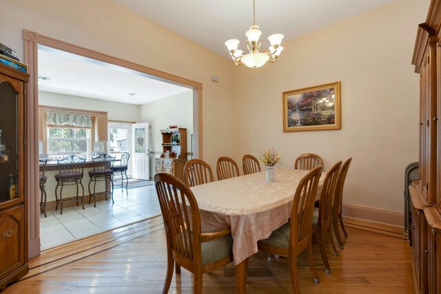 91 Sherman Pl, Jersey City, NJ 07307 - dining room featuring a chandelier, light wood finished floors, and baseboards