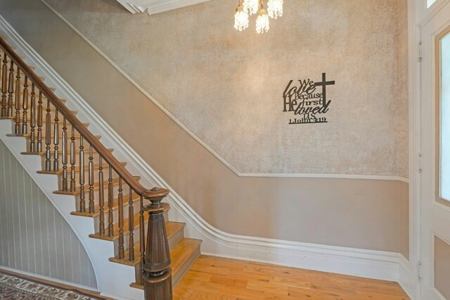 91 Sherman Pl, Jersey City, NJ 07307 - stairway with a chandelier and wood finished floors