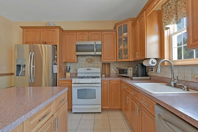 91 Sherman Pl, Jersey City, NJ 07307 - kitchen featuring appliances with stainless steel finishes, a sink, light countertops, decorative backsplash, and glass insert cabinets