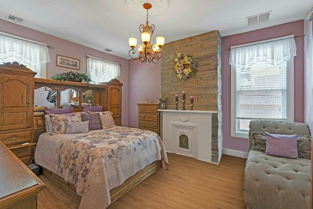 91 Sherman Pl, Jersey City, NJ 07307 - bedroom featuring a chandelier, light wood-type flooring, and multiple windows