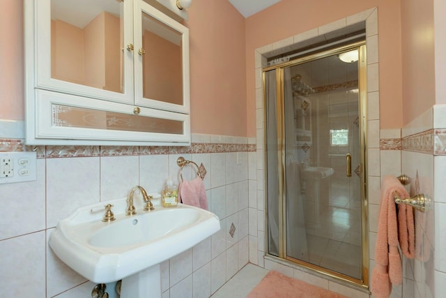 91 Sherman Pl, Jersey City, NJ 07307 - full bathroom with tile walls, a stall shower, a sink, a wainscoted wall, and tile patterned floors