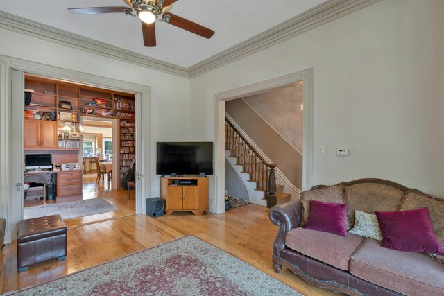 91 Sherman Pl, Jersey City, NJ 07307 - living area with a ceiling fan, light wood-type flooring, a chandelier, ornamental molding, and stairs