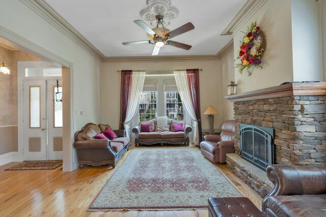 91 Sherman Pl, Jersey City, NJ 07307 - living room featuring light wood-style floors, crown molding, ceiling fan, a stone fireplace, and baseboards