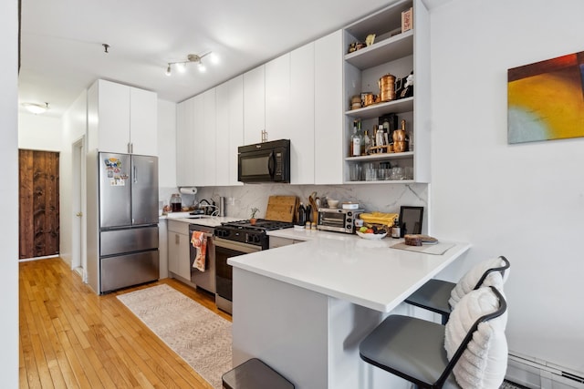 60 Monroe St Unit 8, Hoboken, NJ 07030 - kitchen featuring stainless steel appliances, open shelves, and light wood-style floors