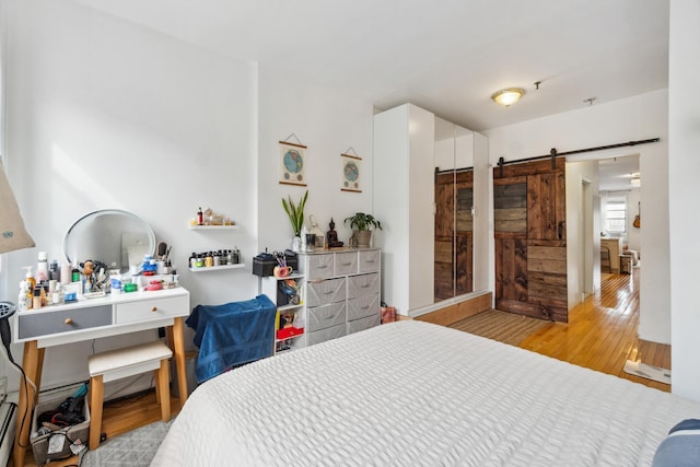 60 Monroe St Unit 8, Hoboken, NJ 07030 - bedroom with a barn door and wood finished floors