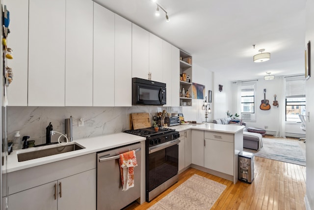 60 Monroe St Unit 8, Hoboken, NJ 07030 - kitchen featuring gas stove, dishwasher, black microwave, light countertops, and open shelves