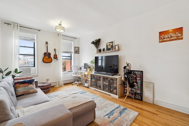 60 Monroe St Unit 8, Hoboken, NJ 07030 - living room with cooling unit, a baseboard heating unit, and wood finished floors