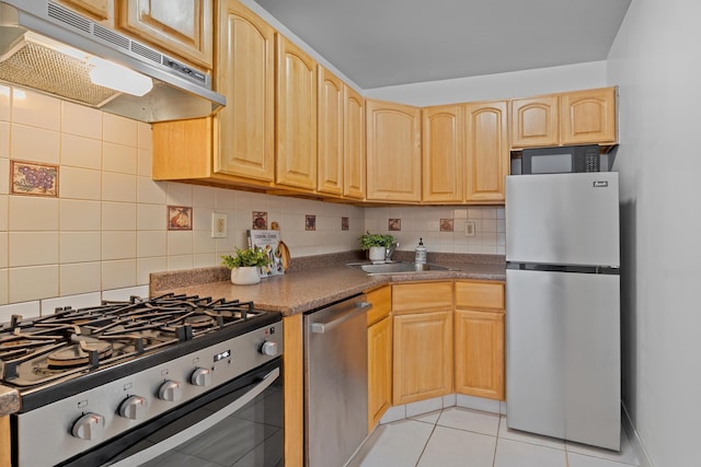 kitchen with light tile patterned flooring, appliances with stainless steel finishes, sink, decorative backsplash, and light brown cabinets