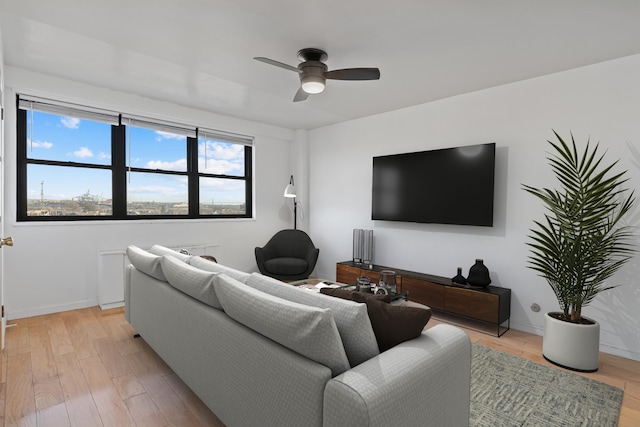 living room featuring ceiling fan and light wood-type flooring