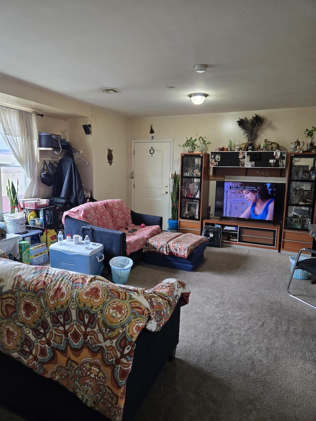 carpeted living area featuring visible vents