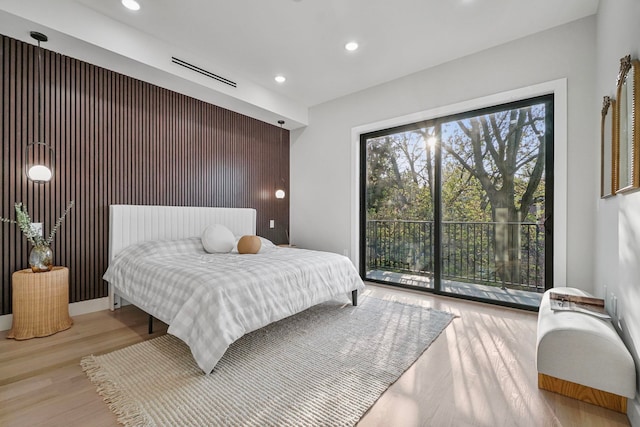 371 New York Ave Unit 2, Jersey City, NJ 07307 - bedroom with recessed lighting, wood finished floors, access to exterior, and an accent wall