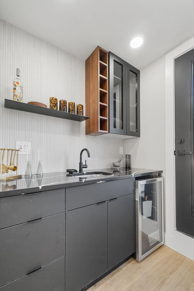 371 New York Ave Unit 2, Jersey City, NJ 07307 - bar area with beverage cooler, light wood finished floors, and a sink