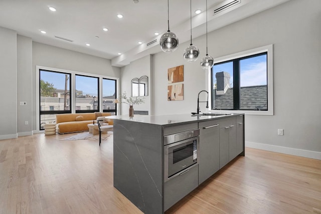 371 New York Ave Unit 2, Jersey City, NJ 07307 - kitchen with a sink, modern cabinets, gray cabinetry, baseboards, and recessed lighting