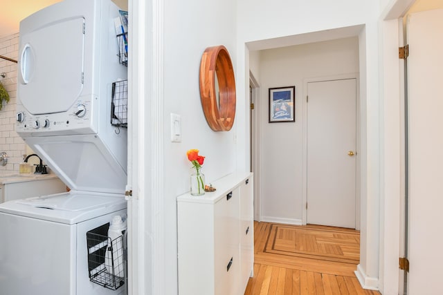 29 51st St Unit B5, Weehawken, NJ 07086 - washroom with stacked washing machine and dryer and parquet flooring