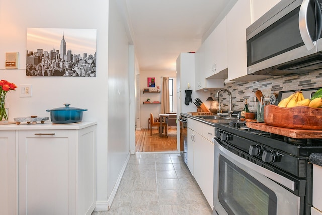 29 51st St Unit B5, Weehawken, NJ 07086 - kitchen featuring appliances with stainless steel finishes, backsplash, and white cabinetry
