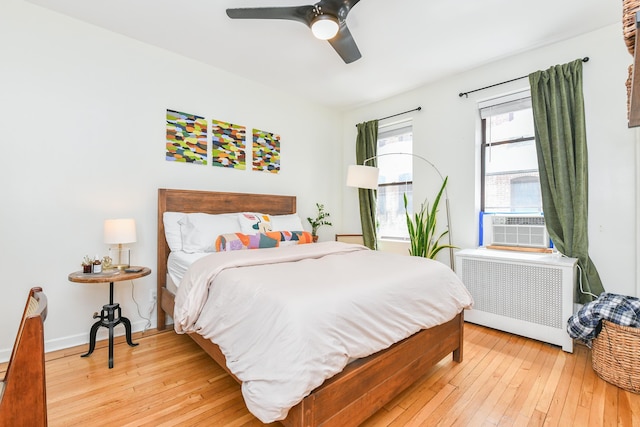 29 51st St Unit B5, Weehawken, NJ 07086 - bedroom with radiator heating unit, light wood-type flooring, ceiling fan, and cooling unit