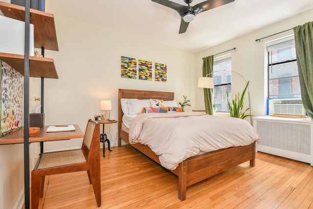 29 51st St Unit B5, Weehawken, NJ 07086 - bedroom featuring radiator heating unit, cooling unit, light wood finished floors, and ceiling fan