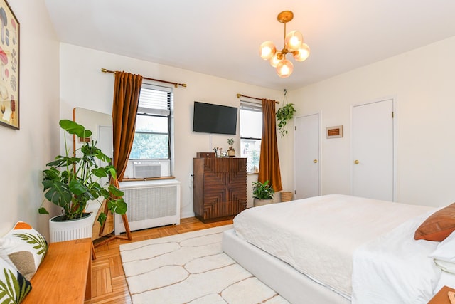 29 51st St Unit B5, Weehawken, NJ 07086 - bedroom featuring radiator heating unit, a chandelier, and cooling unit