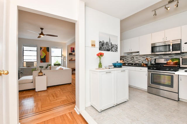 29 51st St Unit B5, Weehawken, NJ 07086 - kitchen featuring stainless steel appliances, backsplash, ceiling fan, and white cabinets