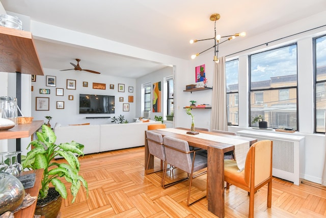 29 51st St Unit B5, Weehawken, NJ 07086 - dining space with radiator heating unit, healthy amount of natural light, a chandelier, and ceiling fan