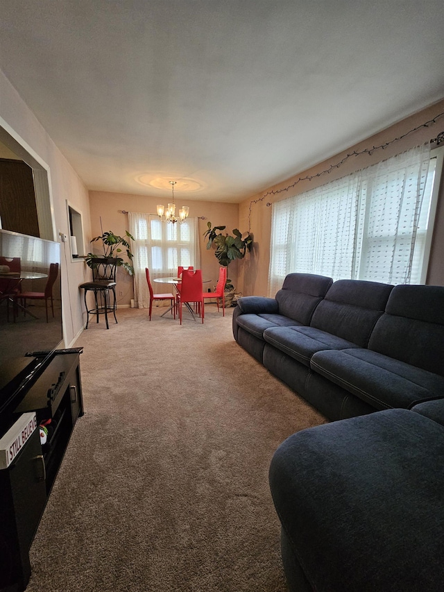 living room featuring carpet flooring and a notable chandelier